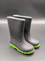 Front view of both black boots with green soles