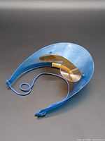 Top view of blue plastic visor with attached sunglasses and cord