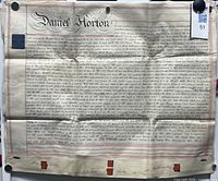 Full view of primary vellum sheet showing calligraphic heading "Daniel Horton", body text, red borders and several wax seals