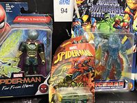 Front view of all three sealed items: Hasbro Mysterio figure, Toy Biz Iceman figure, Hot Wheels Spider-Man car