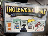Front view of sealed Inglewoodopoly box showing title and landmark graphics