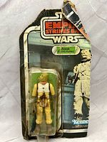 Front view of carded Bossk figure showing distressed card and crushed bubble
