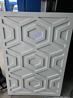 Front view showing complete geometric pattern and white finish