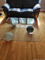 Full view of glass coffee table with marble spheres under glass