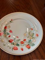 Front view showing strawberry floral pattern and gold rim