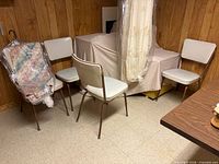 Four vinyl chairs around covered item
