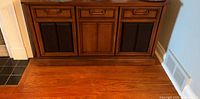 Full front view of Philips wood console stereo cabinet with three black speaker panels