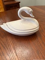 Side view of assembled porcelain swan covered dish