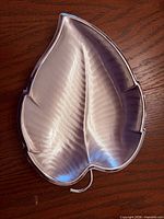 Top view of silver-plated leaf tray showing overall shape, veining and polished finish