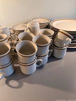Group view of plates and mugs showing quantity and design