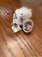 Group shot of clown-snowman, faux-fur bird, crystal basket with rose