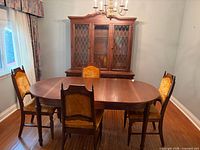 Dining set showing table, four chairs and hutch for scale and style