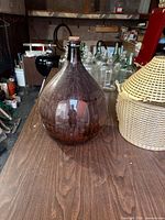 Amber glass demijohn with cork outside basket