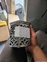 Front view showing ornate cutout metal tealight holder