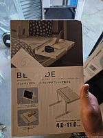 Front of boxed white bedside side table stand showing product image and packaging details