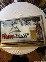 Full view of Coors Light mirrored sign on table