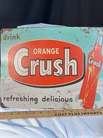 Front view of full Orange Crush sign showing graphics and size reference ruler