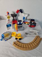 group of GeoTrax track section, controllers, vehicles and accessories on tabletop