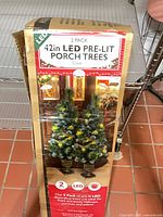 Box showing product image and specifications for 42" LED pre-lit porch trees, 2 pack