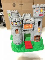 Front view showing three towers, red entry ramp and shield stickers