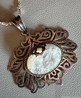 Close-up of filigree pendant and moonstone cabochon