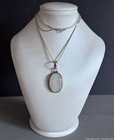 Full view of necklace on bust showing chain length and pendant