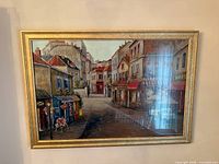 Framed Parisian street scene artwork, front view