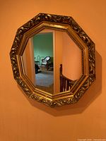 Front view showing mirror shape, frame design, reflective surface