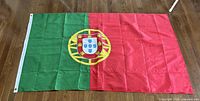 Full view of flag laid flat showing colours, emblem and size