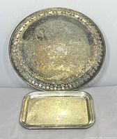 Round and rectangular silver-plated trays front view