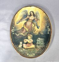 Front view of oval Bradford Exchange plate showing angel, child, kitten scene