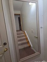 Full view of the rectangular wall mirror mounted vertically