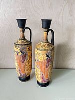 Front view of both amphora vases showing primary mythological figure decoration