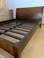 Full view of bed frame showing headboard, side rails, slat base and footboard