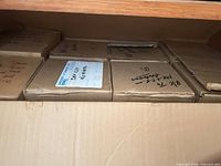 View of multiple labeled cardboard boxes inside larger box