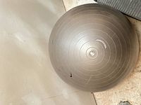 Gray inflatable exercise ball showing overall condition and surface wear