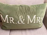 Front view of olive green velvet lumbar pillow showing embroidered "Mr. & Mrs." text
