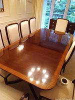 Top view of dining table showing glossy finish and surrounding chairs