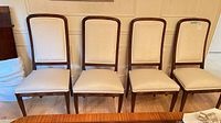 Front view of all four matching upholstered dining chairs