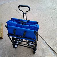 Wagon unfolded on driveway showing handle, frame and wheels