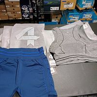 Group shot showing gray bras in packaging and blue shorts