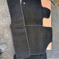 Multiple mats laid out showing driver, passenger, aisle runner and one rear mat