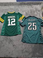 Overview of both youth NFL jerseys laid out flat