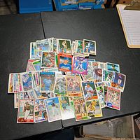 Pile of assorted vintage baseball cards on table