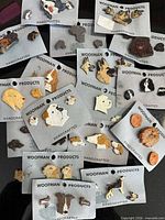 Overview of multiple Woofman Products cards with dog brooch and earring sets