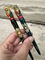 Both pens side by side showing full bodies and painted details