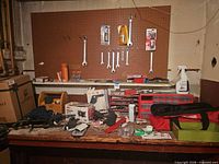 Workbench view with pegboard wrenches, drawer organizer, assorted hand tools