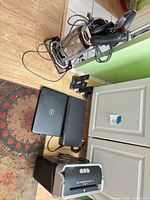 All lot items grouped: vacuum, laptop, DVD player, shredder, cordless phones