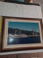 Front view of framed sailboat print showing full artwork, mat, and frame