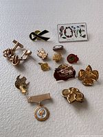 All items laid out: pins, cufflinks, medal